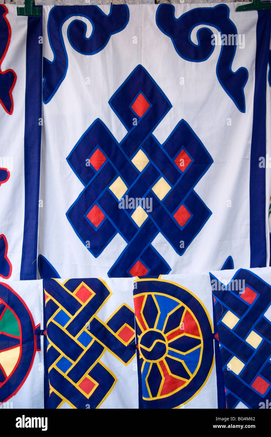 Detail of a  textile with traditional Tibetan symbols used as a door cover for sale at a market in Lhasa, Tibet Stock Photo
