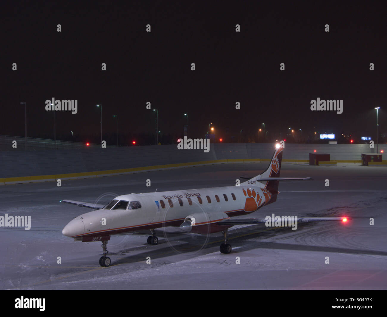 Bearskin Airlines plane sits on the tarmac with its propellers spinning in Ottawa, Ontario, after a light snow has fallen. Stock Photo