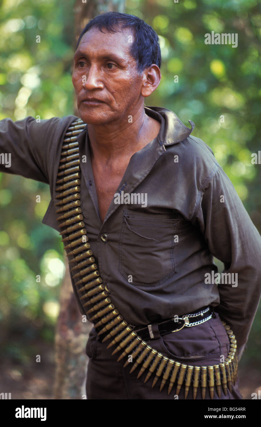 Old guerrilla with machine gun bullets in a gun belt in the Ixcan Jungle Guatemala Stock Photo