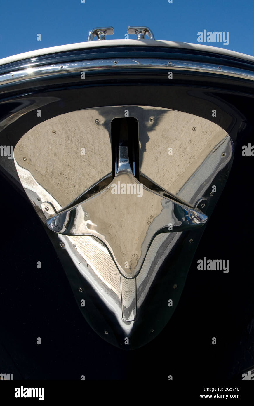 Stainless steel Bruce type anchor on powerboat bow Stock Photo