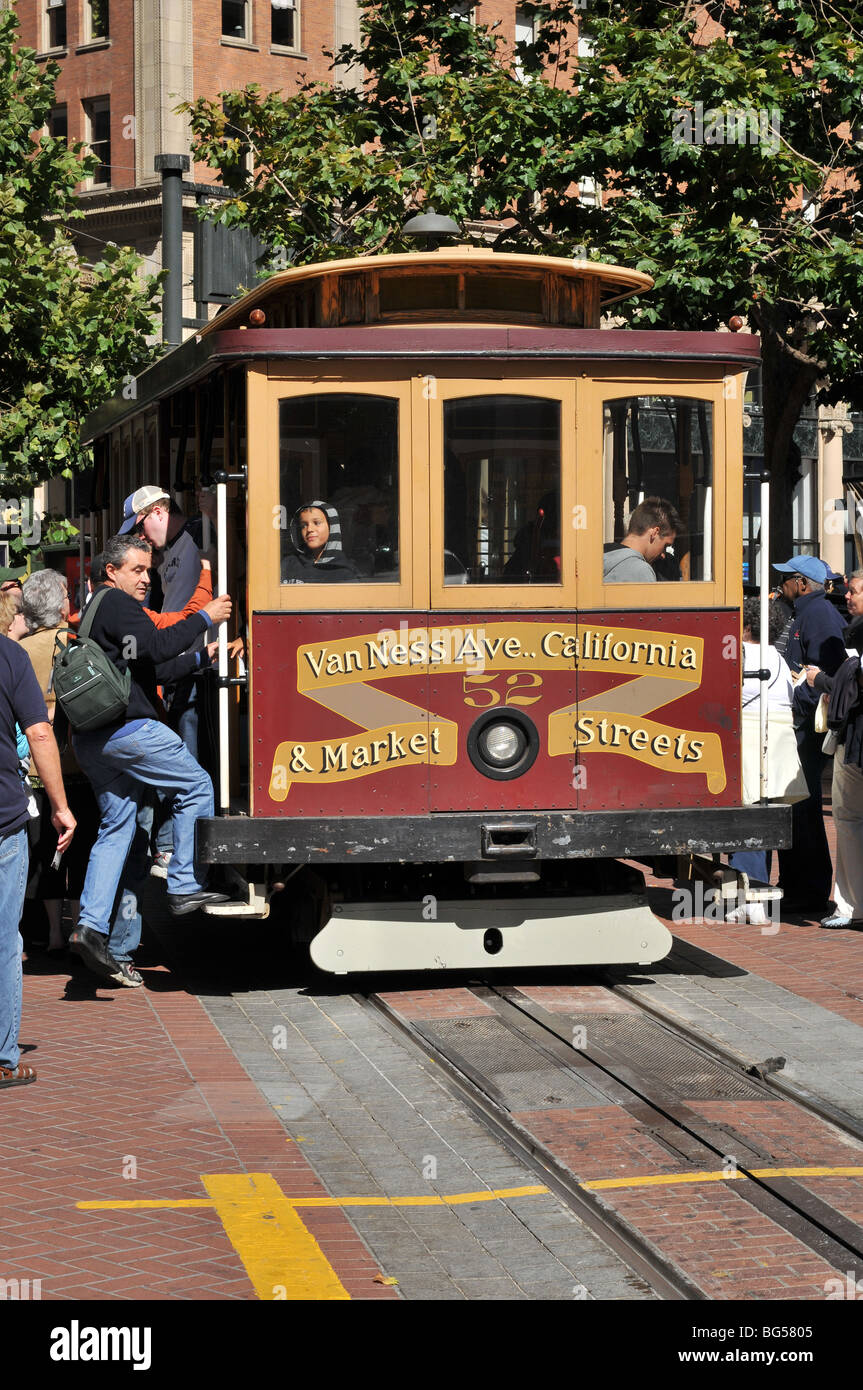 Tourists board a street car at the Market Street terminus of the California Street line in San Francisco, California. Stock Photo