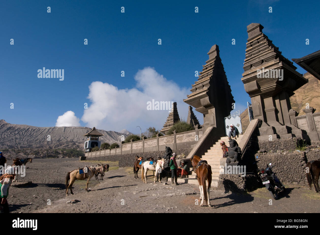 Poten Hindu temple with Mount Bromo steaming in the background Stock Photo