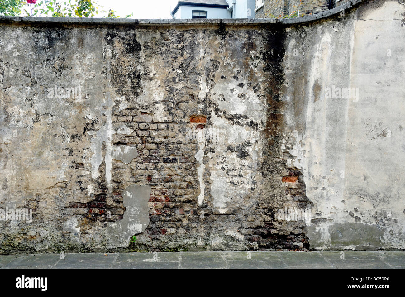 Old distressed brick and rendered wall Limehouse London England UK Stock Photo