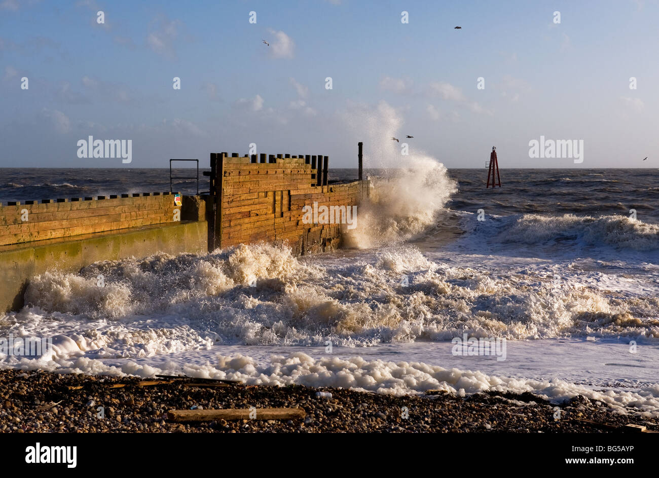 Rough sea at the entrance to Rye Harbour in East Sussex.  Photo by Gordon Scammell Stock Photo