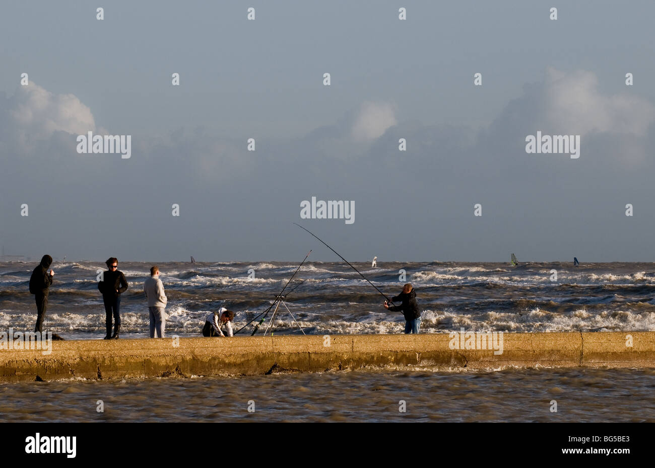 Anglers fishing at the entrance to Rye Harbour in East Sussex.  Photo by Gordon Scammell Stock Photo