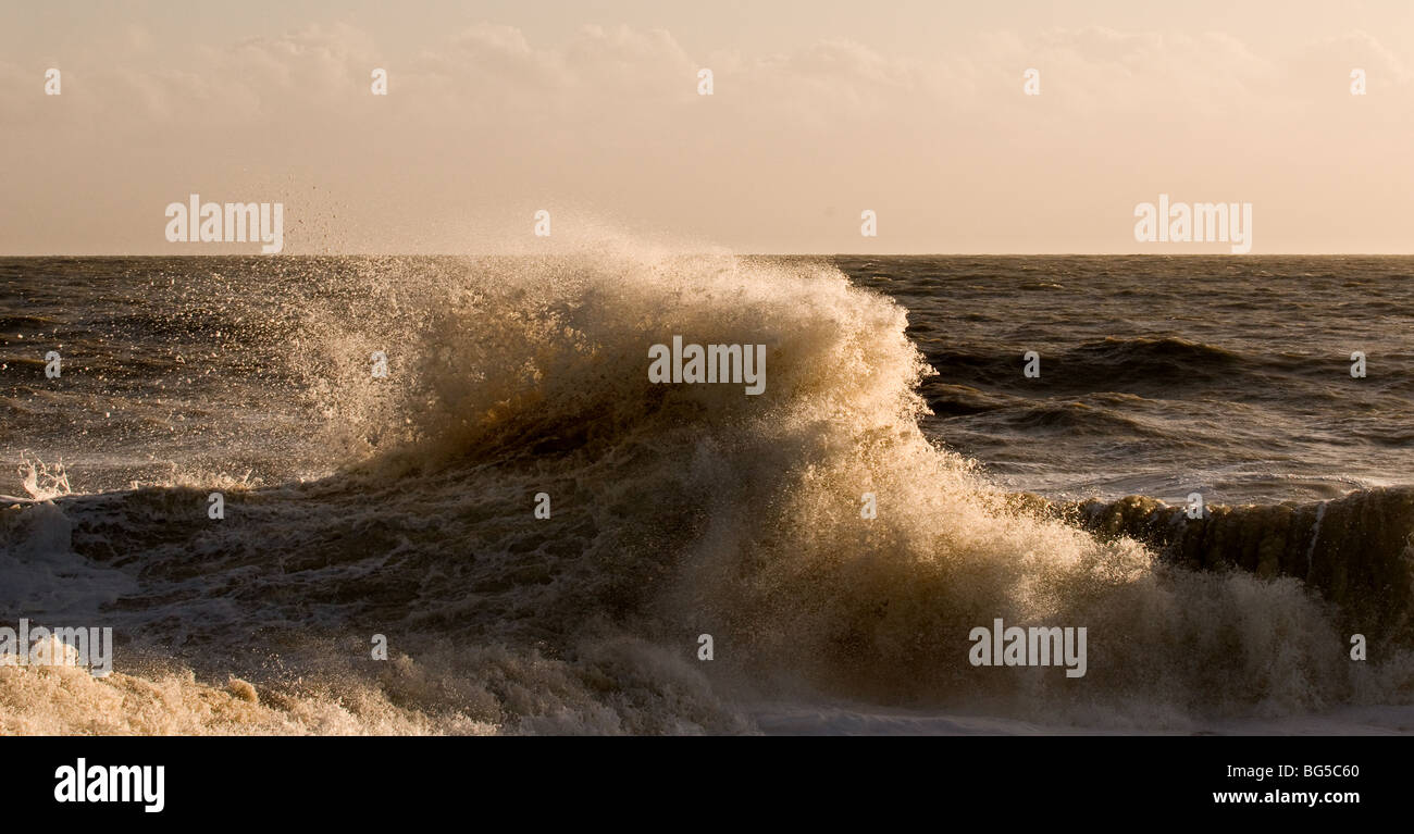 A wave in rough weather on Winchelsea beach in East Sussex.  Photo by Gordon Scammell Stock Photo