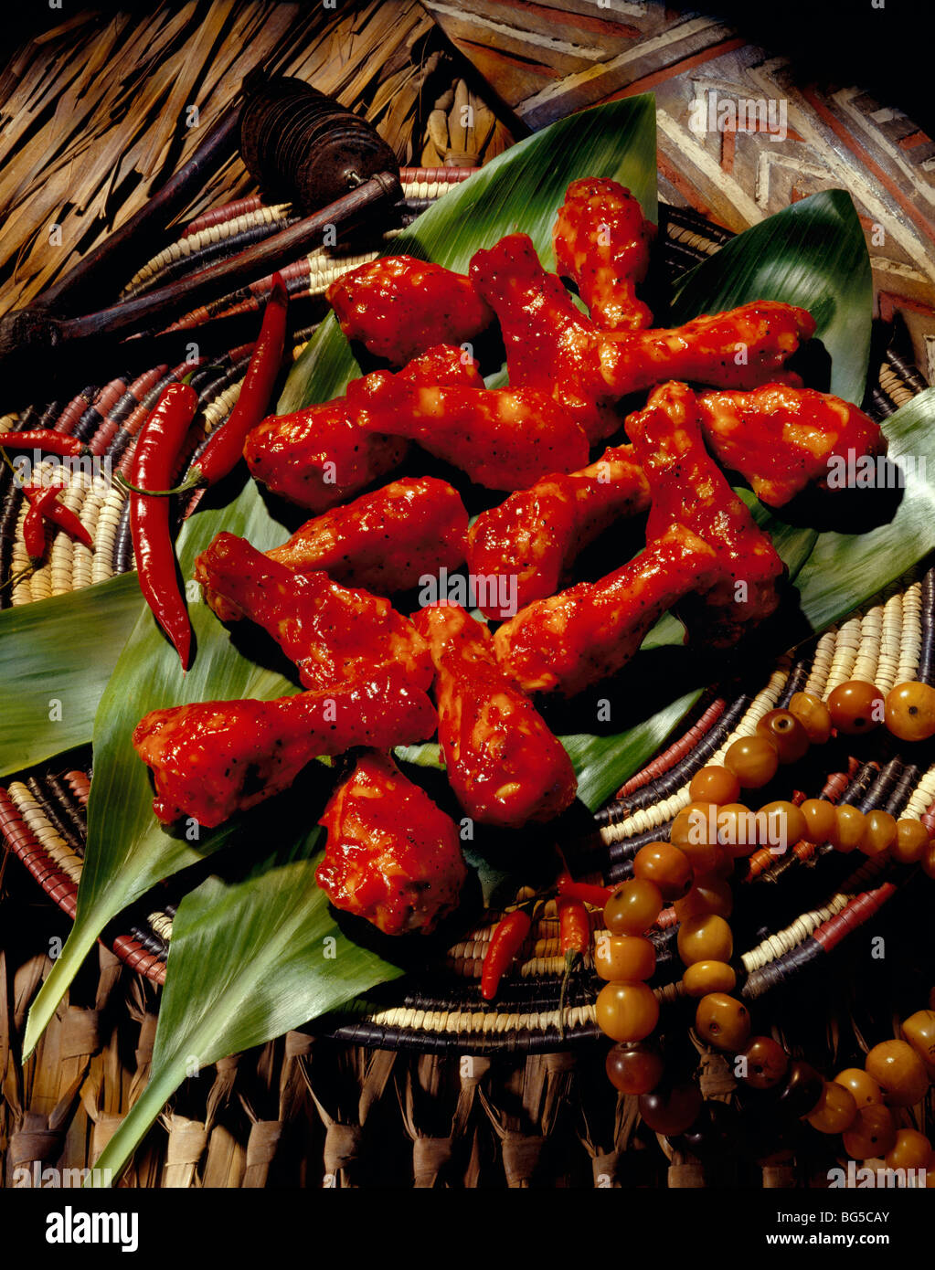 Spicy chicken drumsticks on leaves Stock Photo