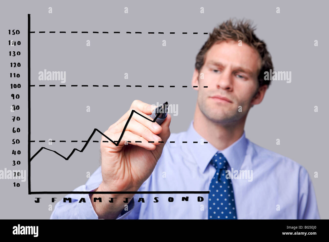 Businessman drawing a graph on a glass screen Stock Photo