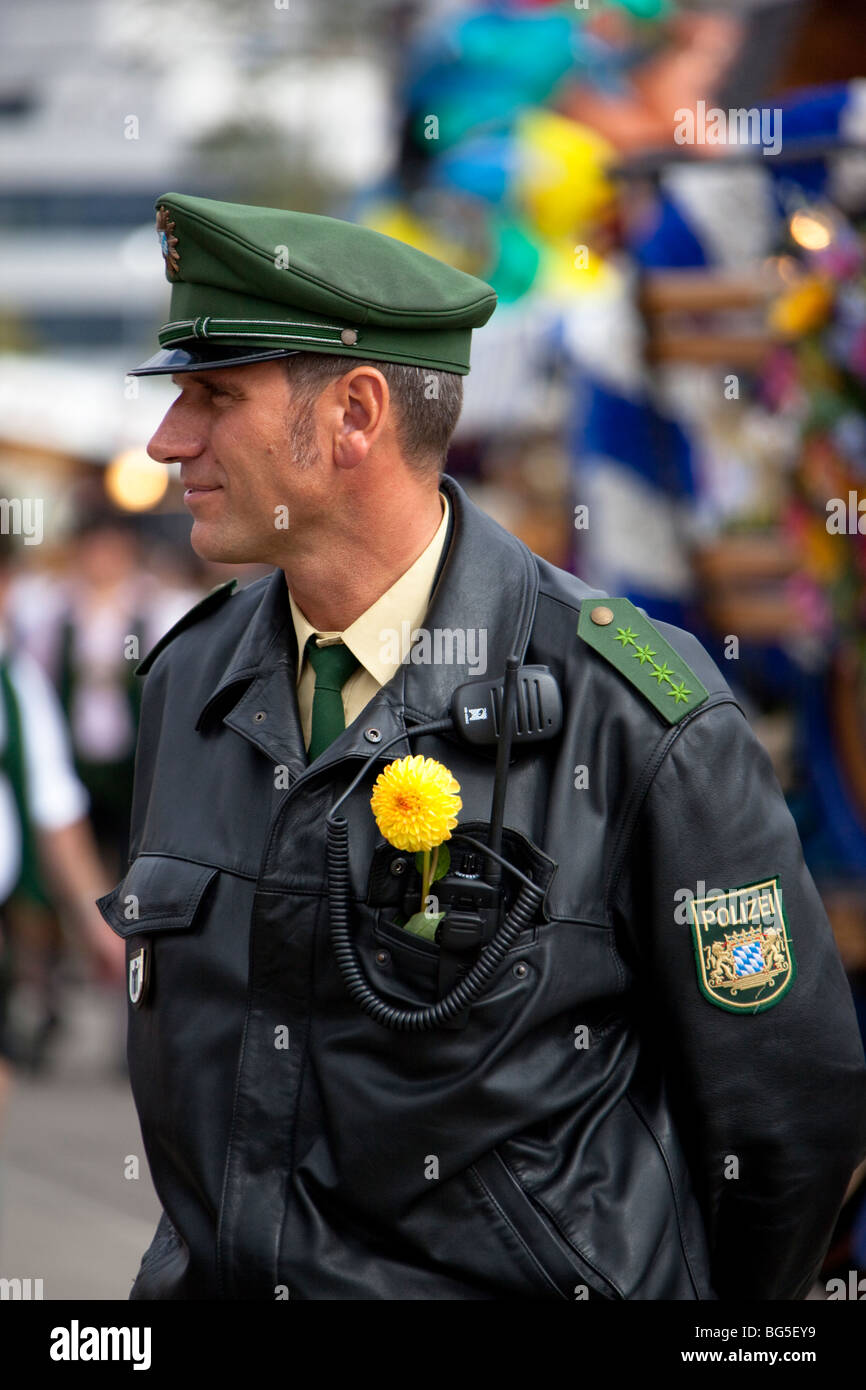 german policeman with flower on the uniform taking care of security at the Oktoberfest in Munich Stock Photo