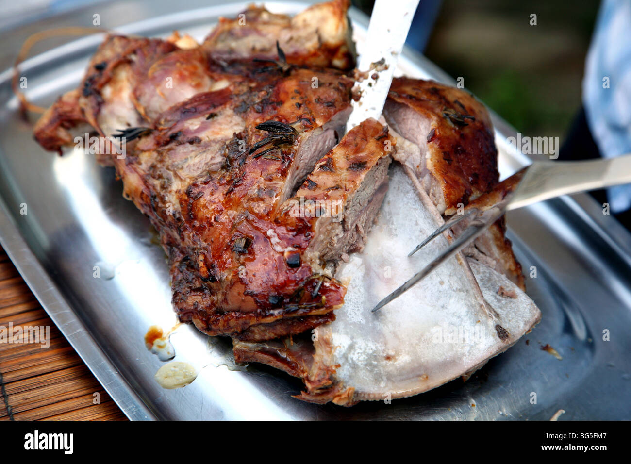 Carving roast shoulder of lamb, London Stock Photo