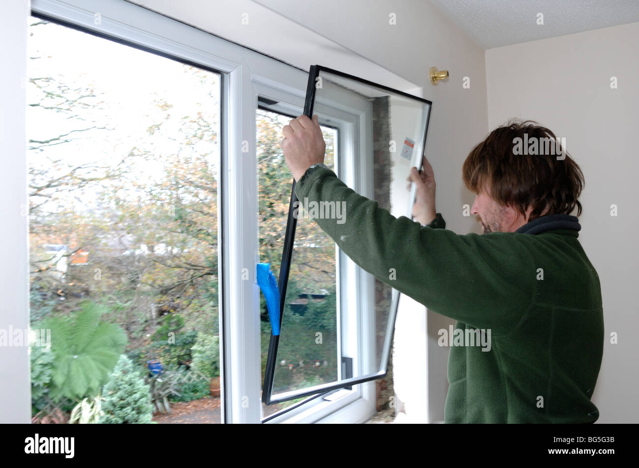 Installing new double glazed windows in a house Stock Photo Alamy