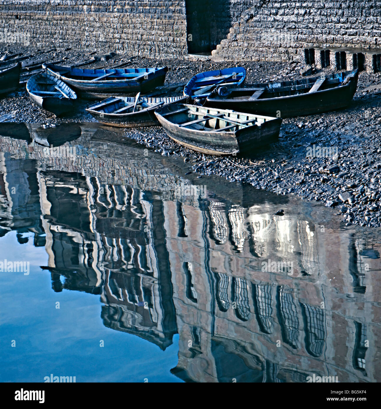 Small fishing boats low tide Stock Photo - Alamy