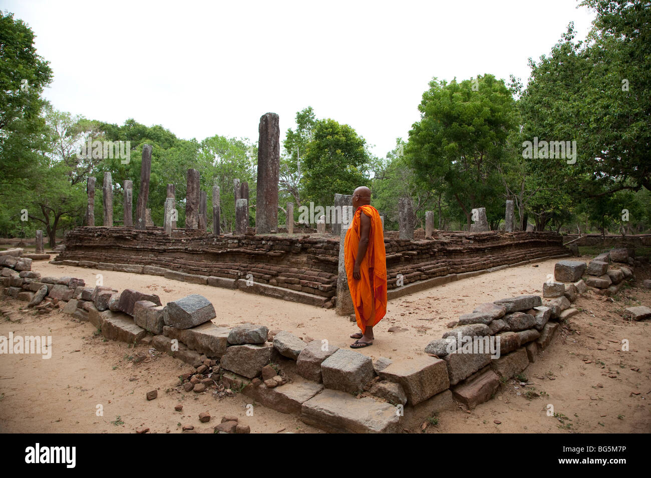A monk in the Magul Maha Viharaya ruins in the Lahugala National park, SrI Lanka. (Near the town of Pottuvil.) Stock Photo