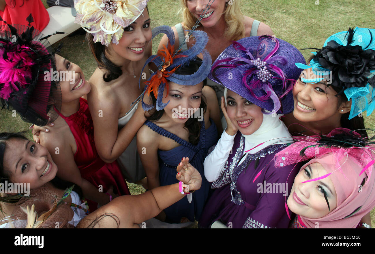 Elegantly dressed women wearing hats during a horse race, Dubai, United Arab Emirates Stock Photo