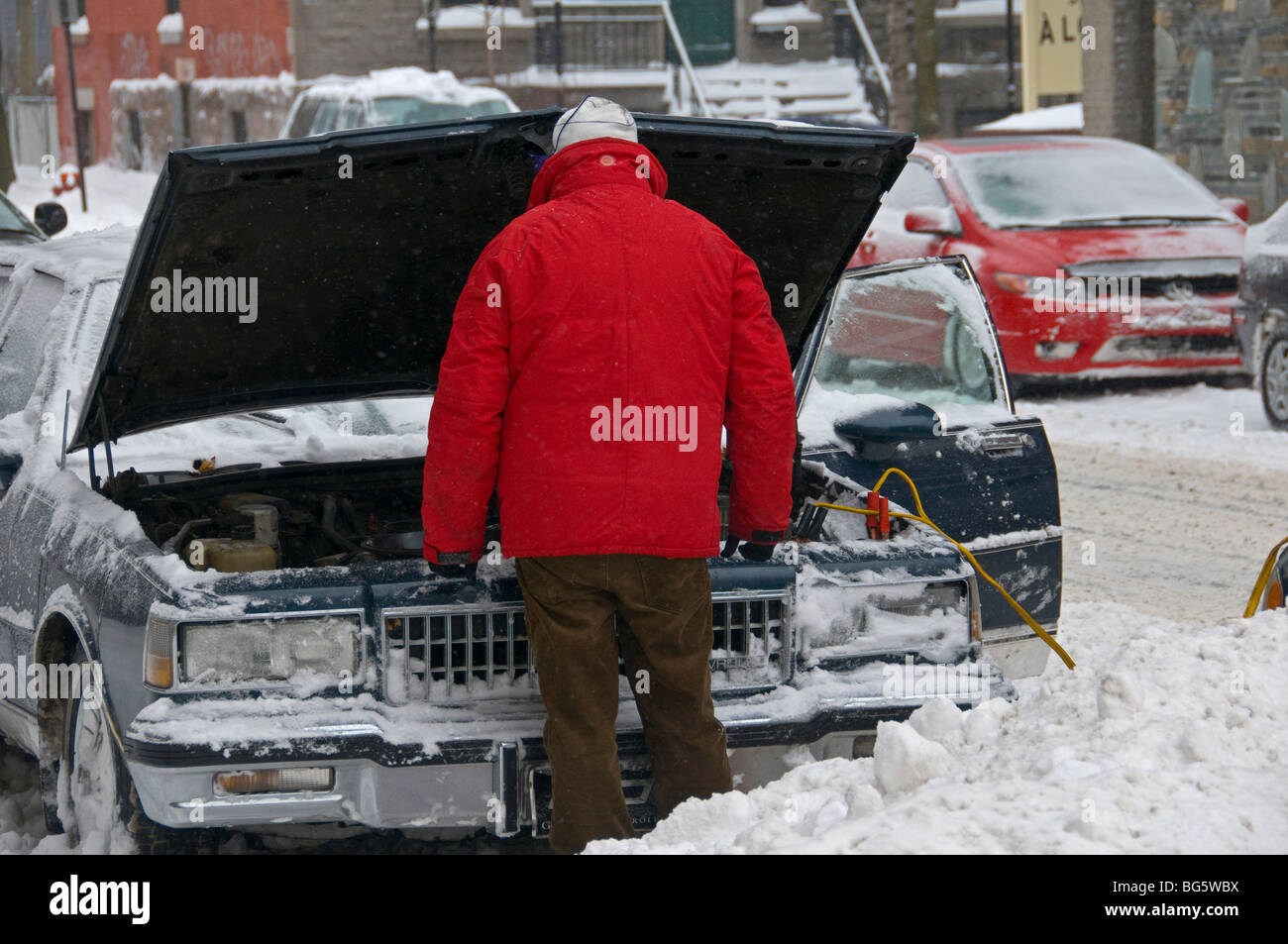 Boosting car battery in winter Stock Photo Alamy
