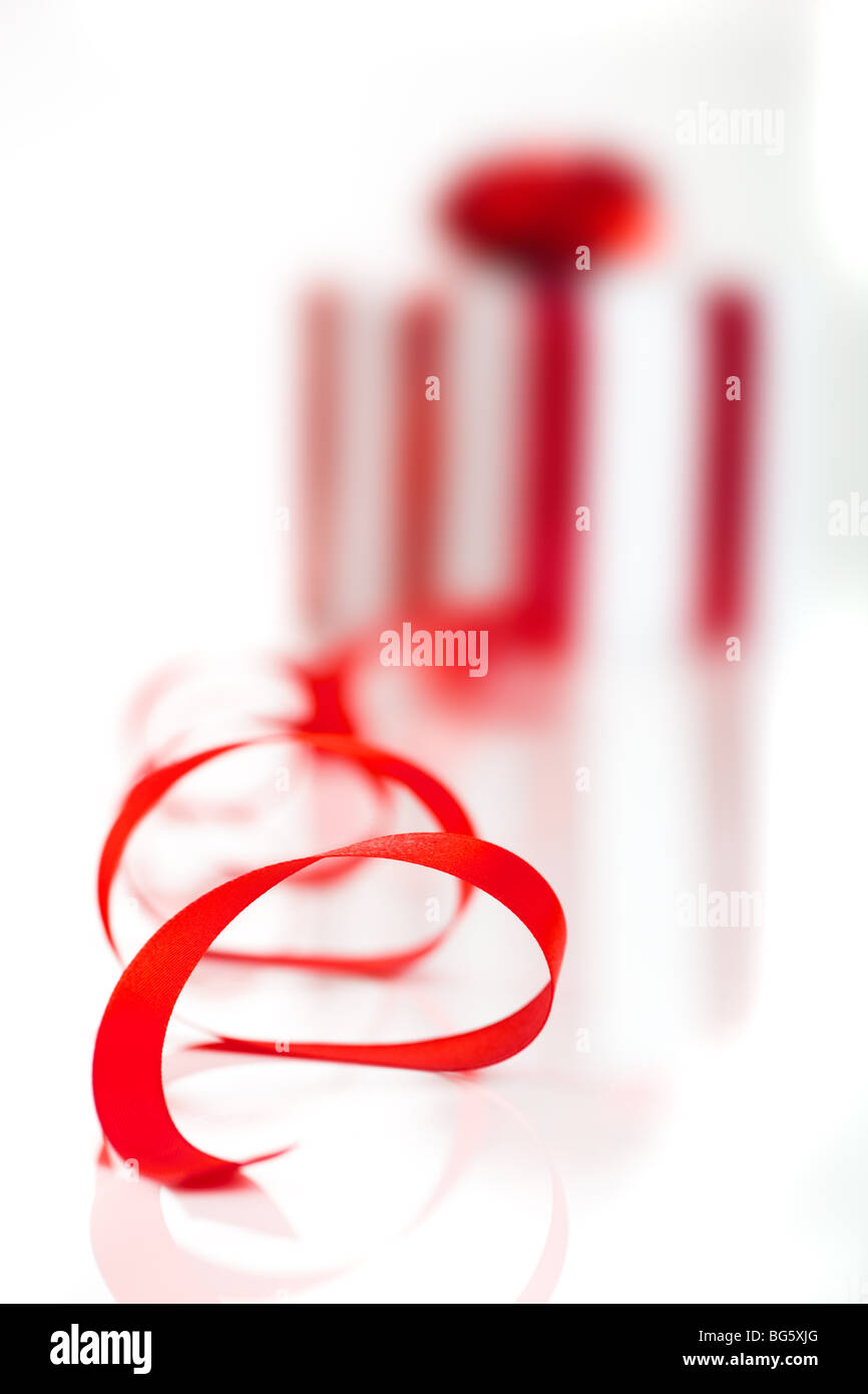 Gift wrapped with a red ribbon on a white background, Focus is on the ribbon Stock Photo