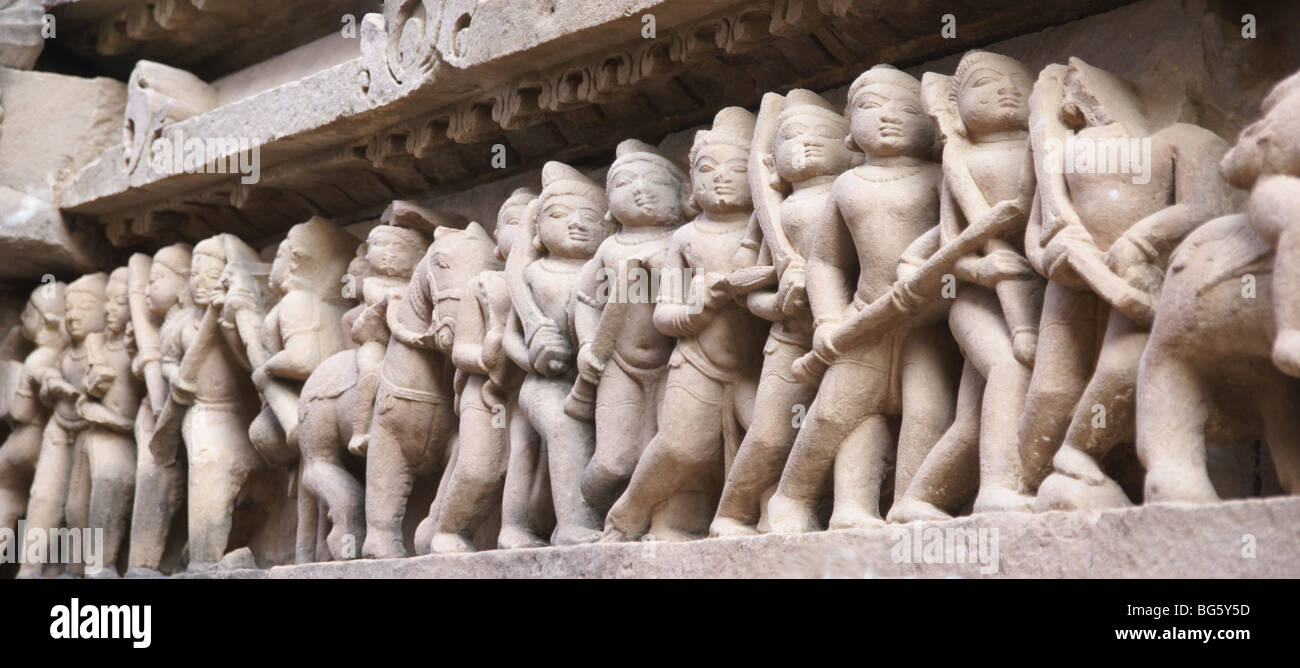 Soldiers and horsemen of the king, carvings on Lakshmana Temple at Khajuraho in India, Asia Stock Photo