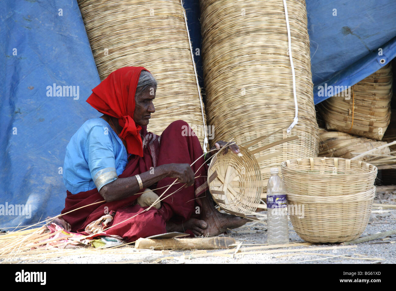 Old lady making bamboo baskets near City Market, Bagalore Stock Photo