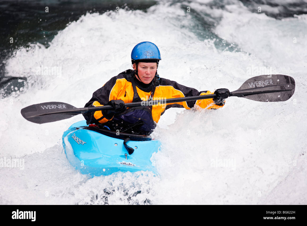 Heather Armitage paddles through a hole in a whitewater kayak on the