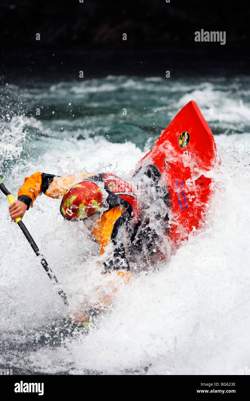Andrew Jobe dives into a hole in a whitewater kayak on the Kananaskis River, Kananaskis County