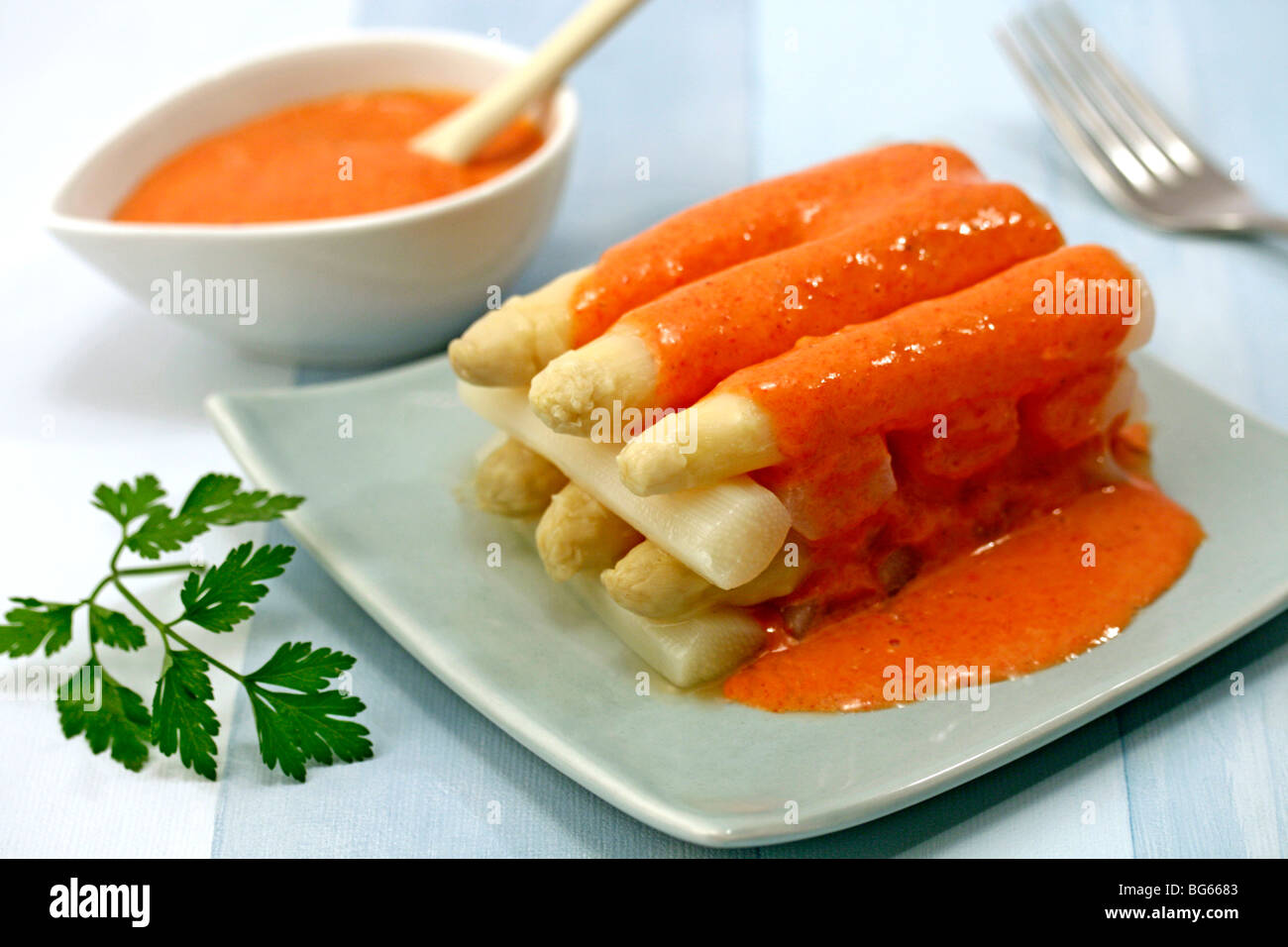 White asparagus with red peppers sauce. Recipe available Stock Photo