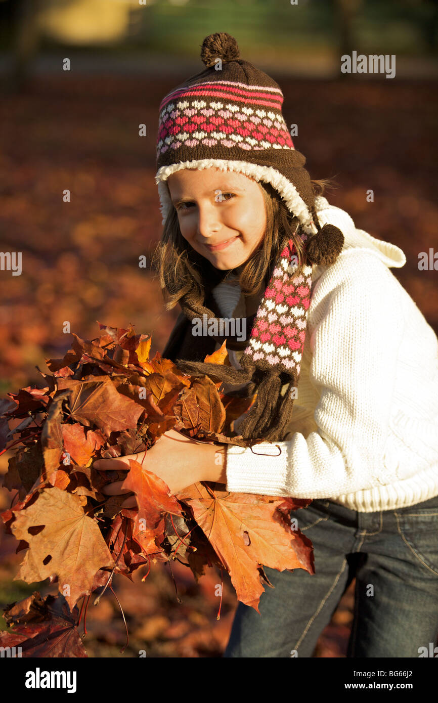 Happy young girl playing with the autumn leaves Stock Photo - Alamy