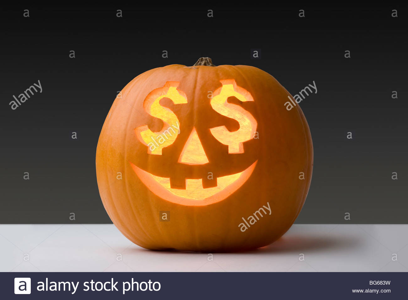 pumpkin-with-a-smiling-face-and-dollar-signs-for-eyes-stock-photo