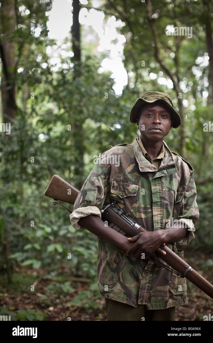 An armed ranger keeps watch over the Kakamega Forest Reserve in Western Kenya where deforestation is a problem. Stock Photo