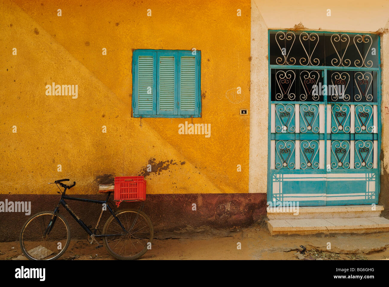 Shutters painted in blue and closed to keep out the sun. Stock Photo