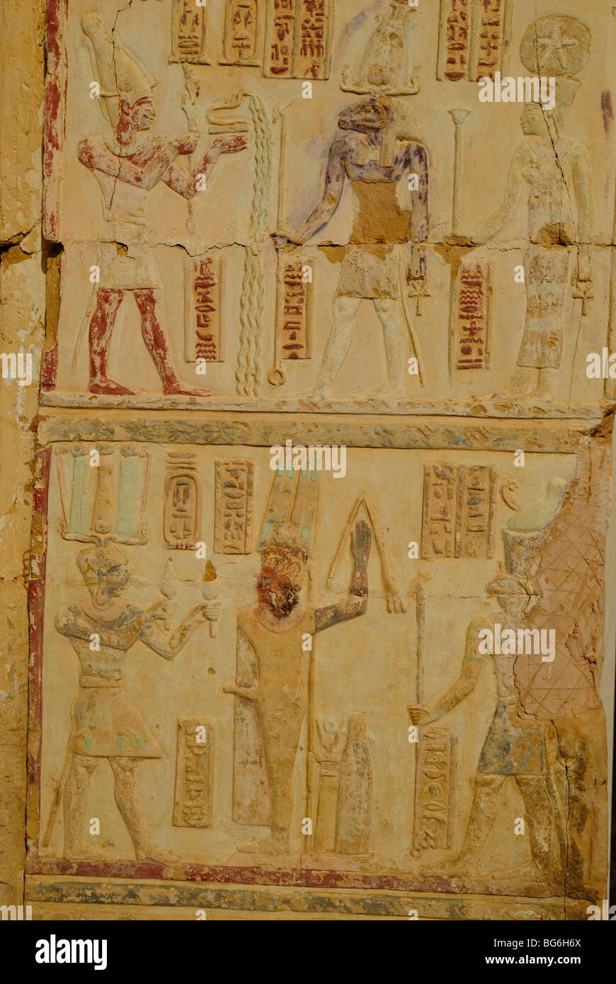 Colored reliefs of Amun-re and Mut gods at Deir al-Hagar Temple, western desert of Egypt Stock Photo