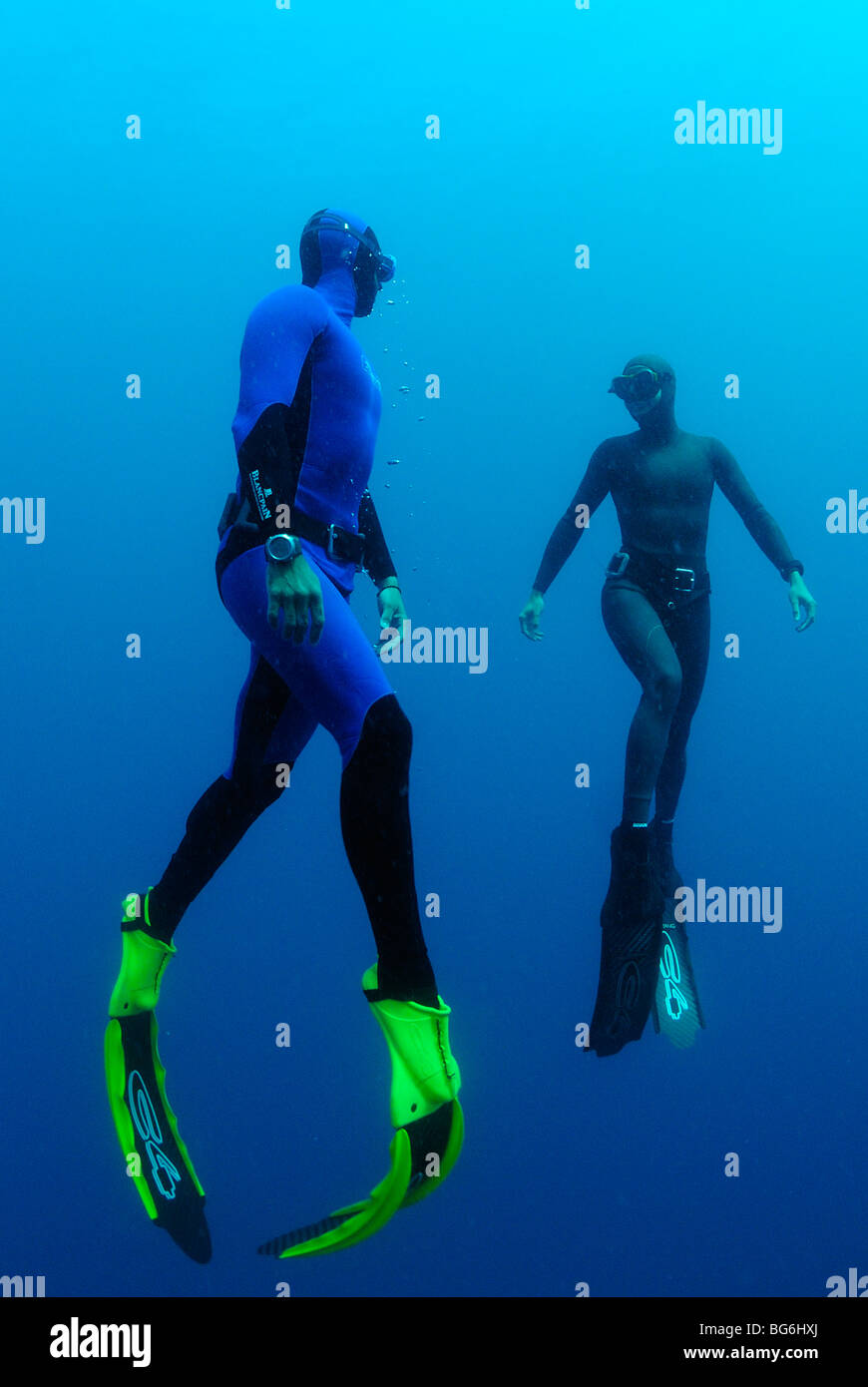 Two free divers going up in the Mediterranean Sea, off Monaco Stock Photo