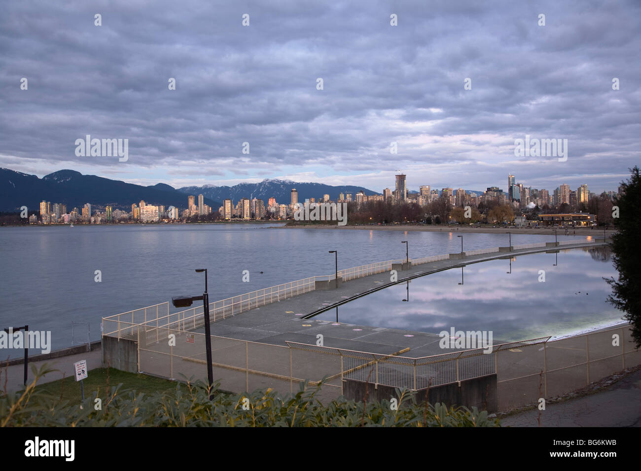 Kitsilano Outdoor swimming pool and the downtown Vancouver skyline on an gloomy winter day, BC, Canada Stock Photo