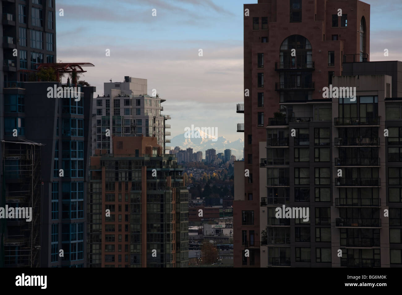 Highrise residential buildings in downtown Vancouver, Canada frame Mt Baker in Washington State