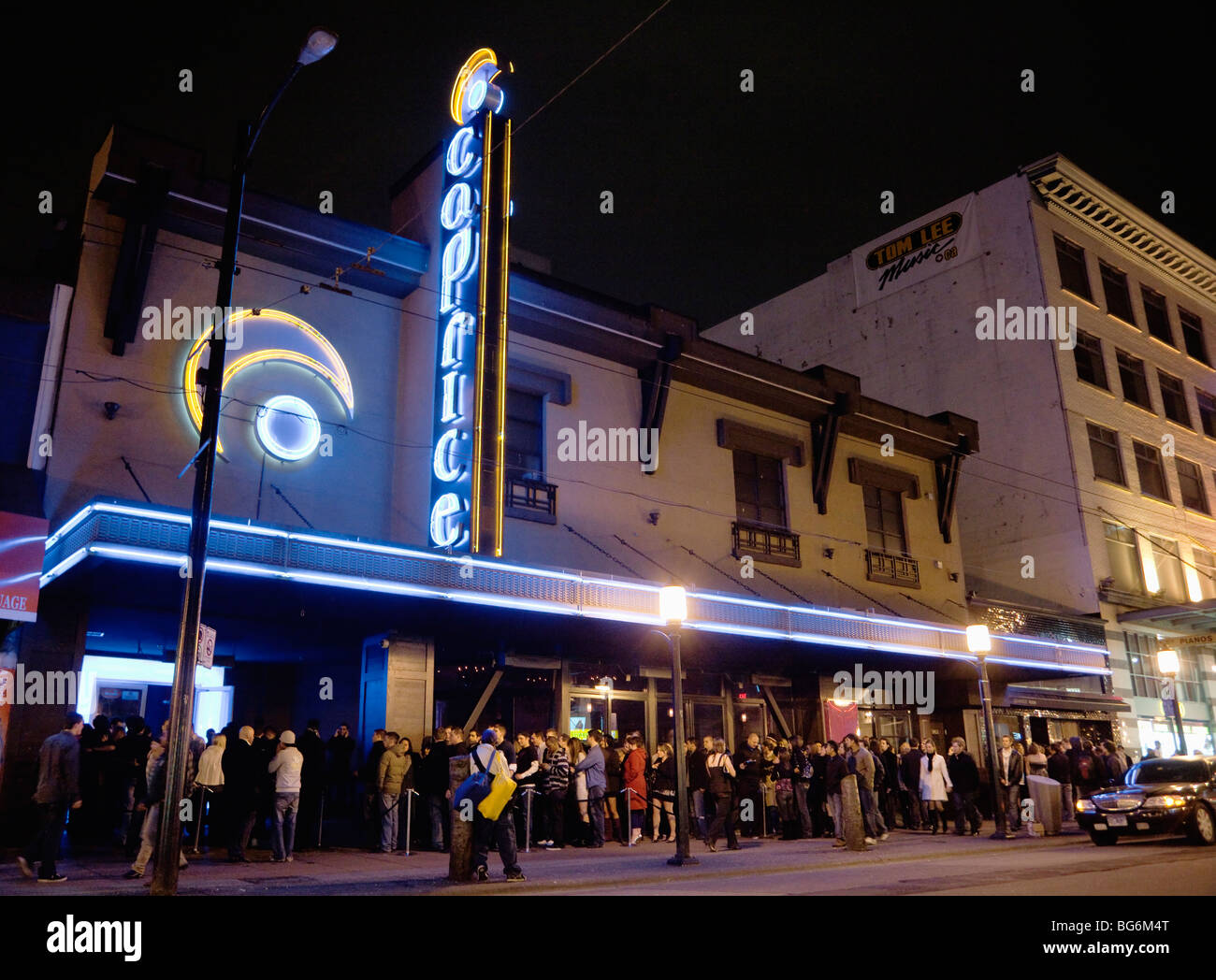 A queue of patrons outside of Caprice Night Club in the Granville Entertainment District, downtown Vancouver, BC, Canada Stock Photo