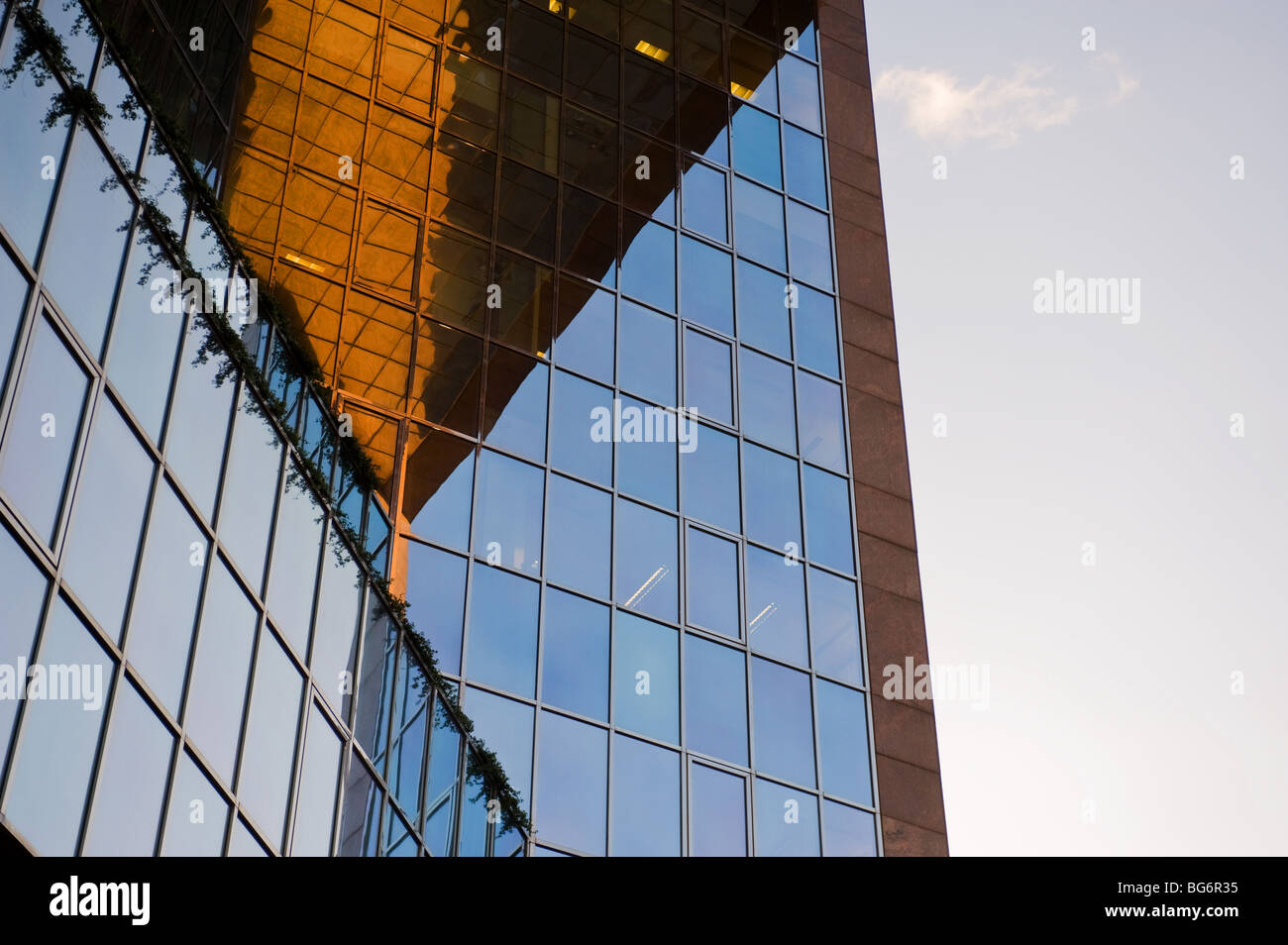 Reflections in the glass walls of a modern office block in London.  Photo by Gordon Scammell Stock Photo