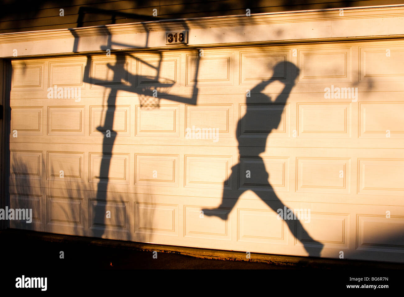 shadow of a basketball player making a dunk Stock Photo