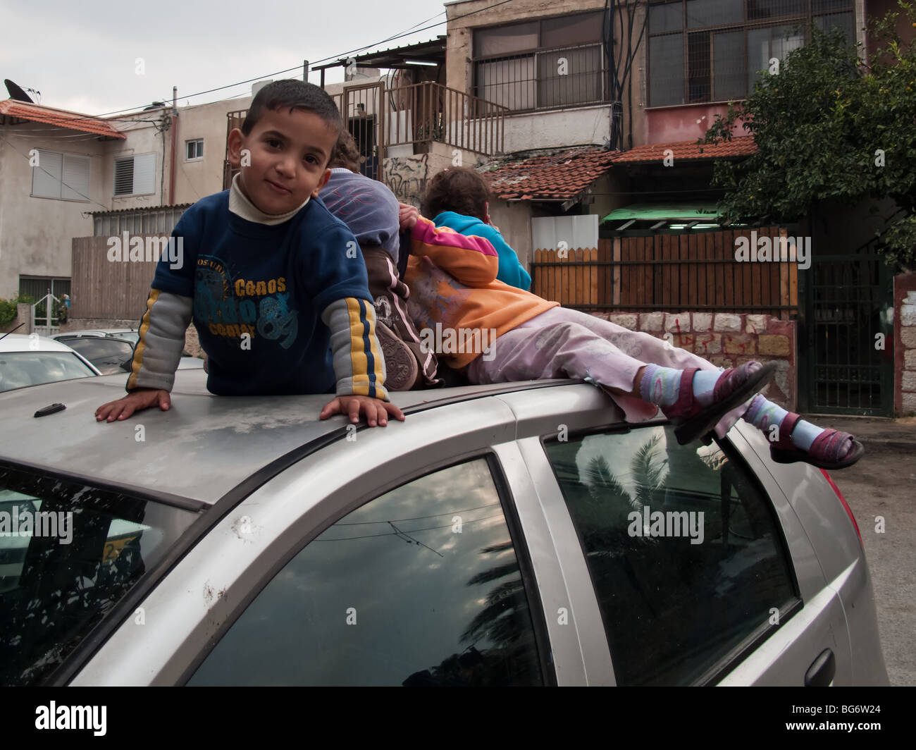 Palestinian Children on a Car Roof in Sheik Jarach East-Jerusalem Stock Photo