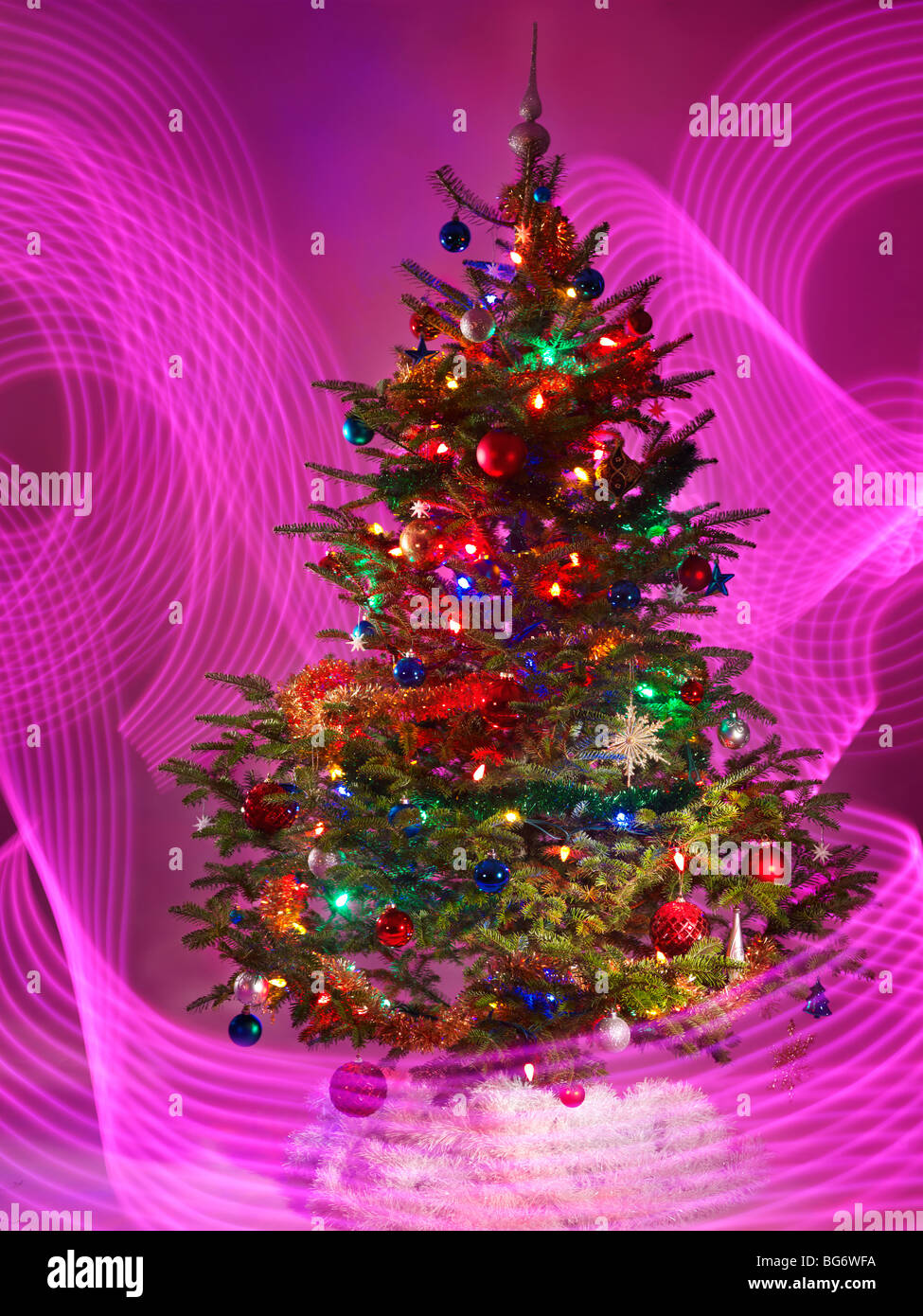Decorated Christmas tree with purple lighting effects around it Stock Photo Alamy