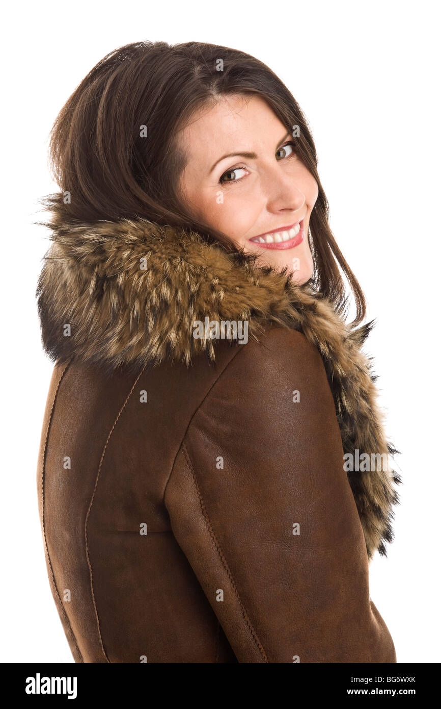 Portrait of smiling woman wearing sheepskin isolated on white ...