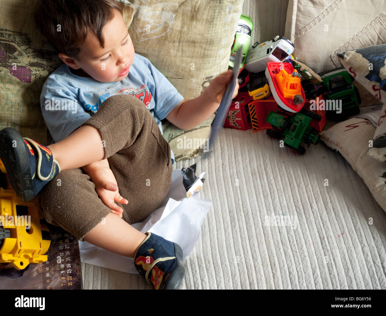 Little boy playing with toys Stock Photo - Alamy