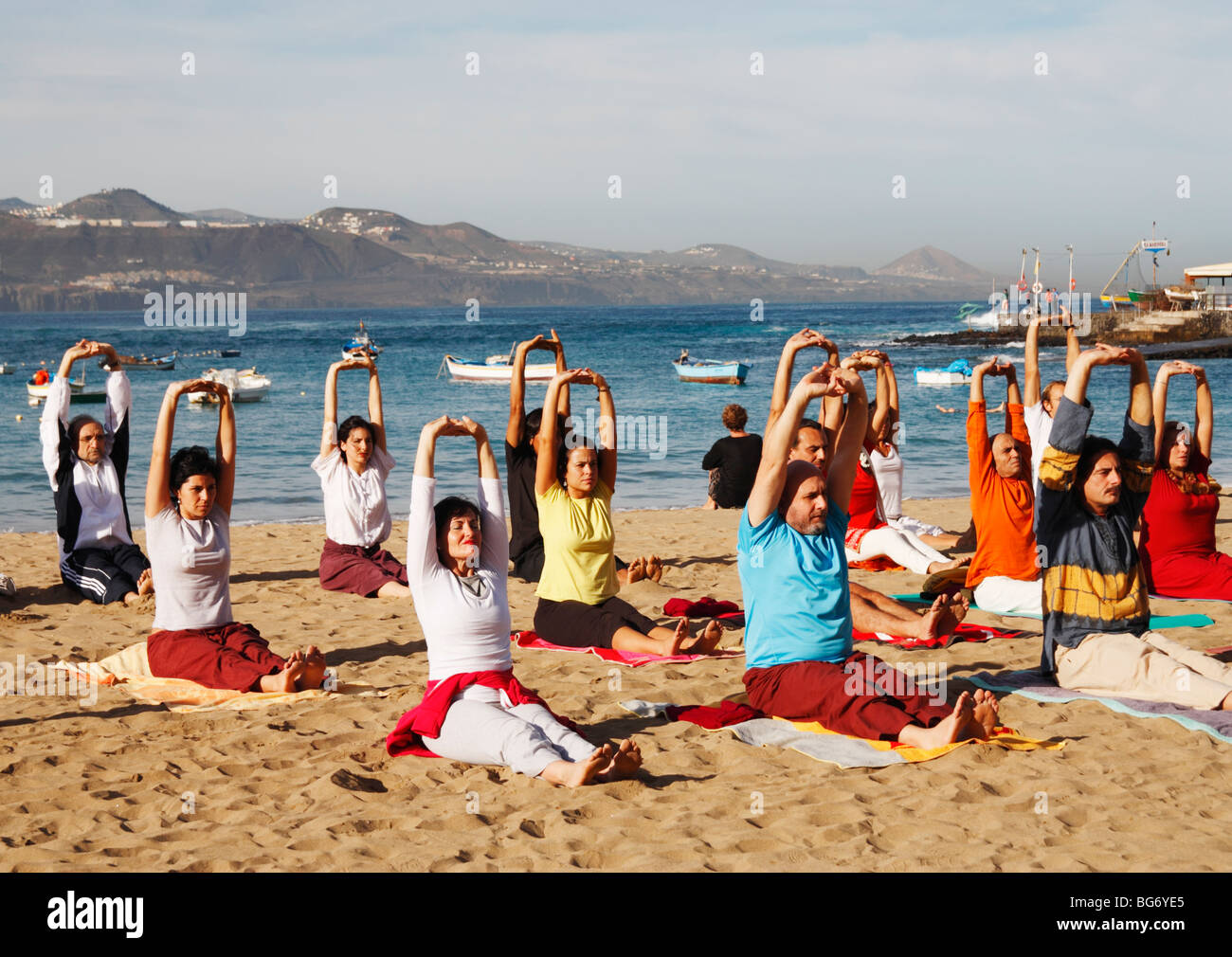 Group yoga session on beach in Spain Stock Photo Alamy