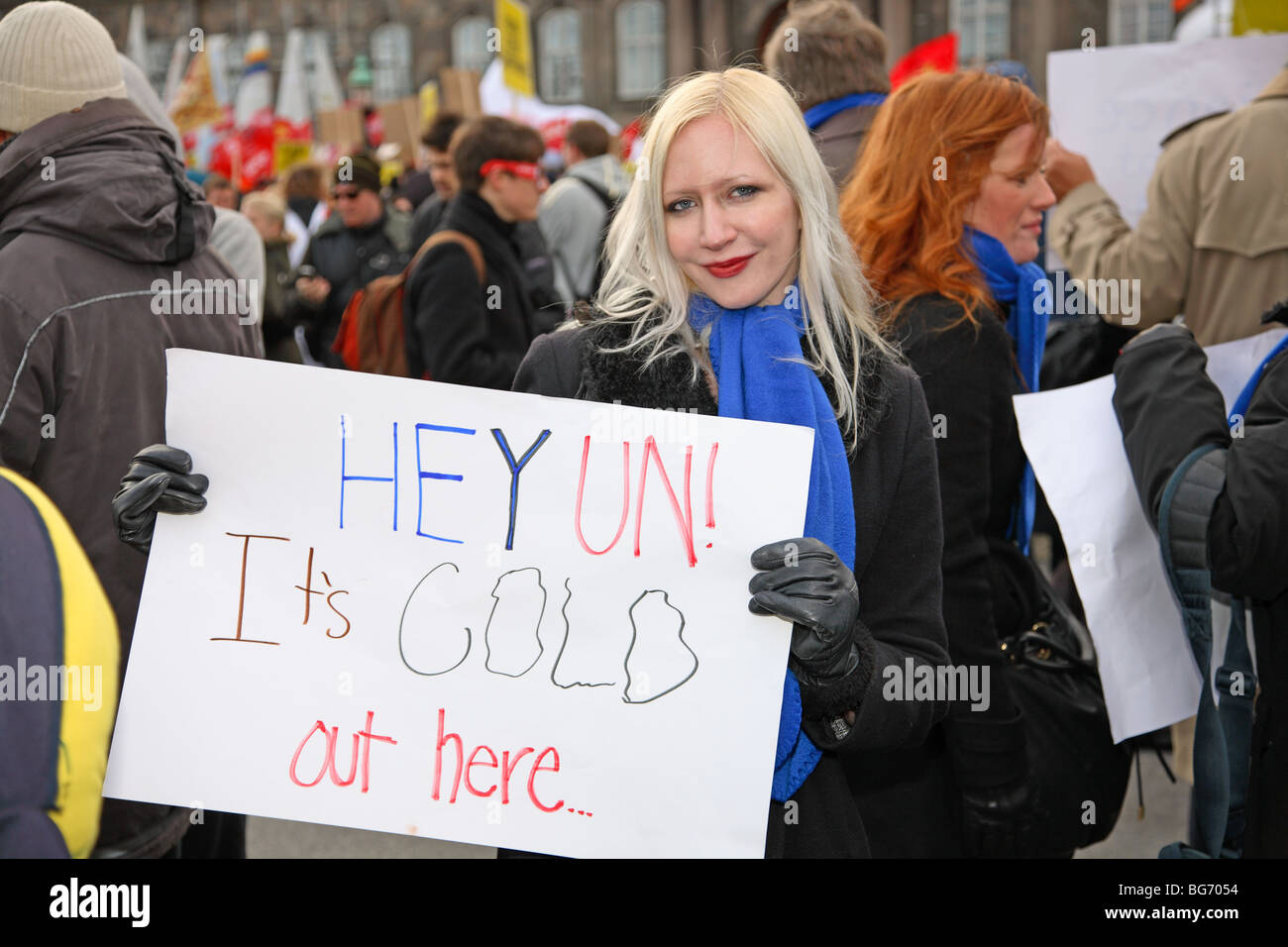 Demonstrator holds placard in front of the Parliament building in Copenhagen at the UN Climate Change Conference. Stock Photo