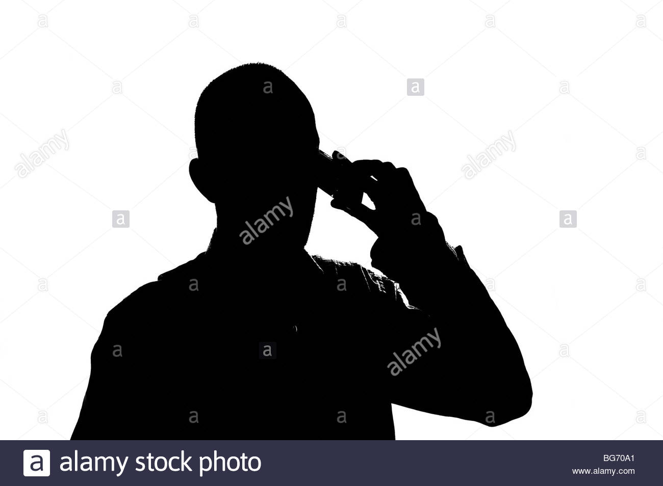 Silhoutted man on mobile phone Stock Photo