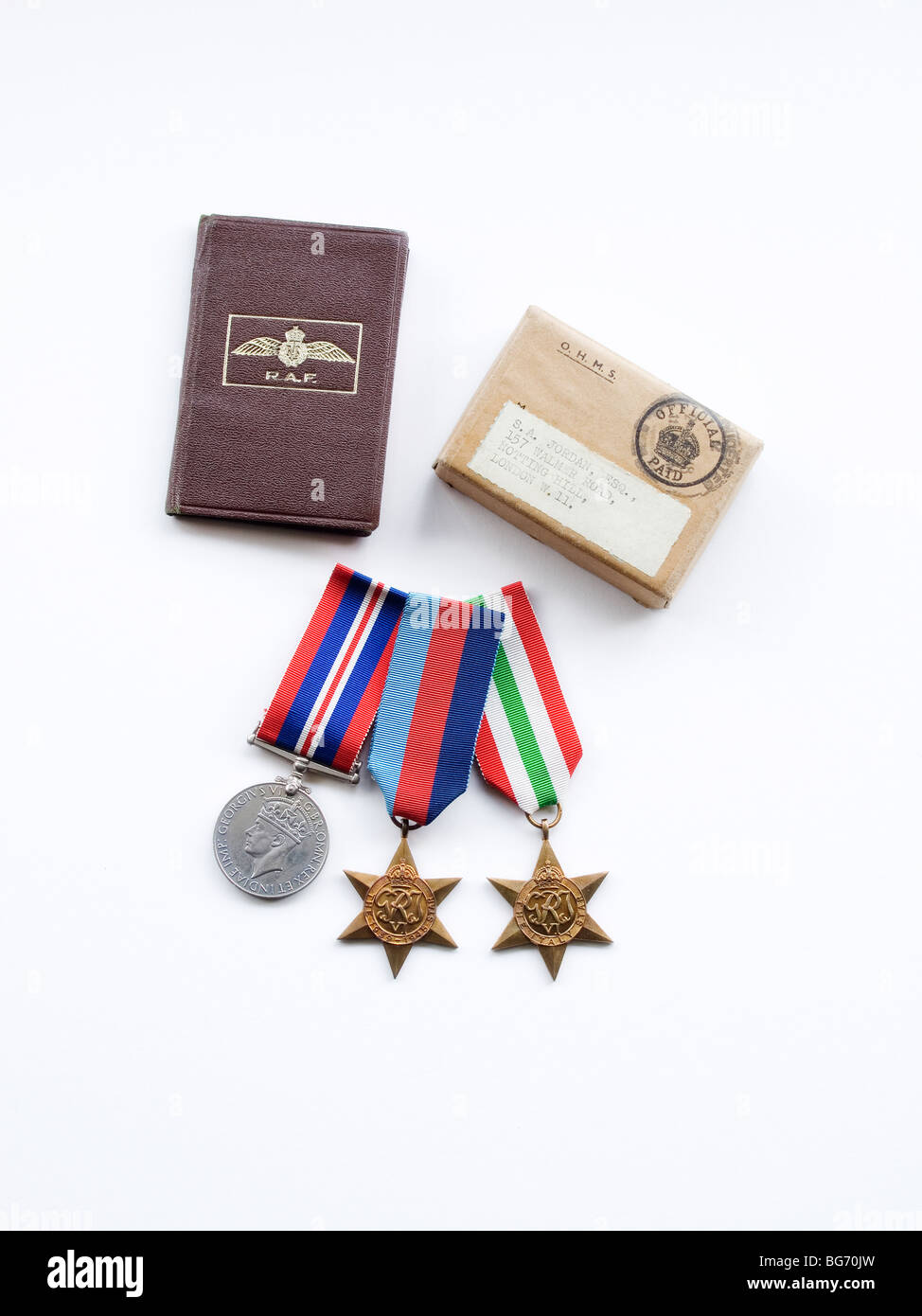 World War 2 Medals awarded to British and Commonwealth Troops with the original box and an RAF notebook on a white background Stock Photo