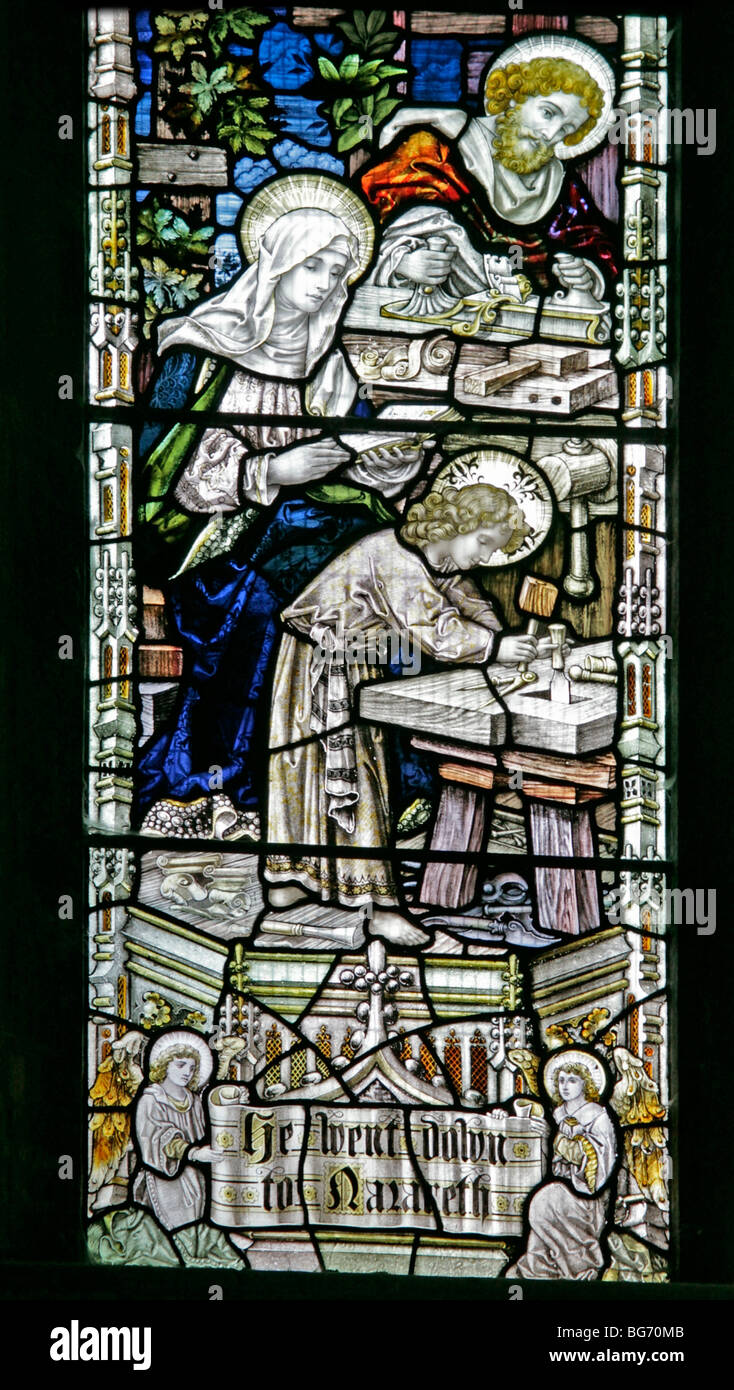 A stained glass window by Percy Bacon & Brothers, depicting Jesus as a twelve year old boy in Nazareth going about the trade of Carpenter Stock Photo