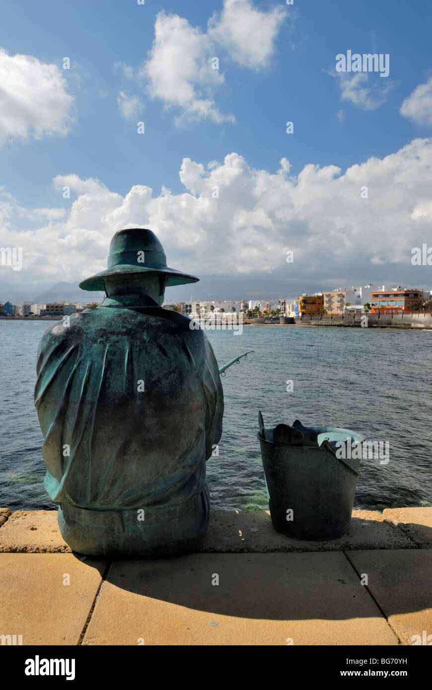 A sculpture of a fisherman on the pier of the small coastal town of Arinaga. Arinaga, Gran Canaria, Canary Islands, Spain, Europ Stock Photo