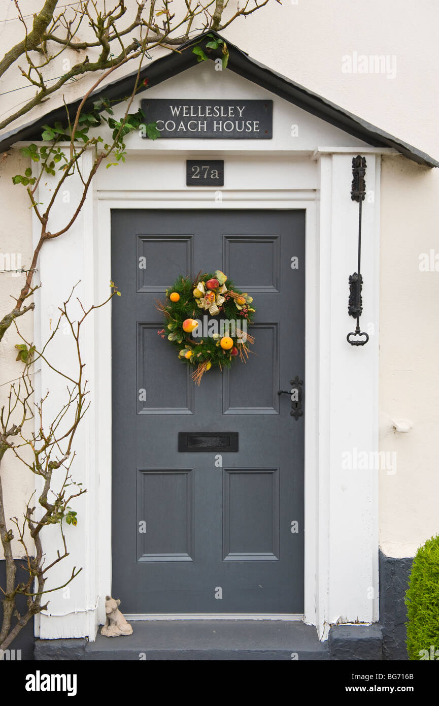 Xmas wreath on front door with old bell pull period house in Usk Monmouthshire South Wales UK Stock Photo