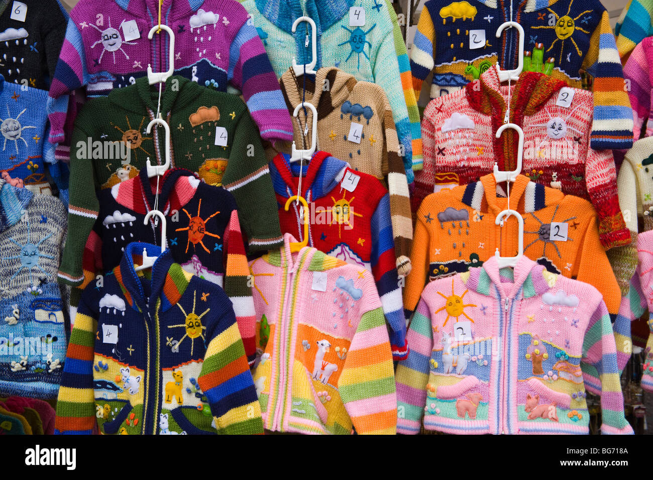 Colourful woolen knitwear for sale on market stall during Usk Winter Festival Usk Monmouthshire South Wales UK Stock Photo
