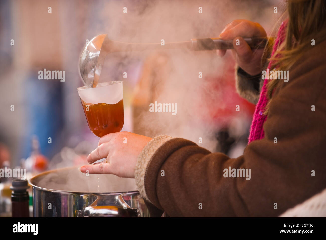 Hot mulled wine being sold on market stall at Usk Winter Festival Usk Monmouthshire South Wales UK Stock Photo