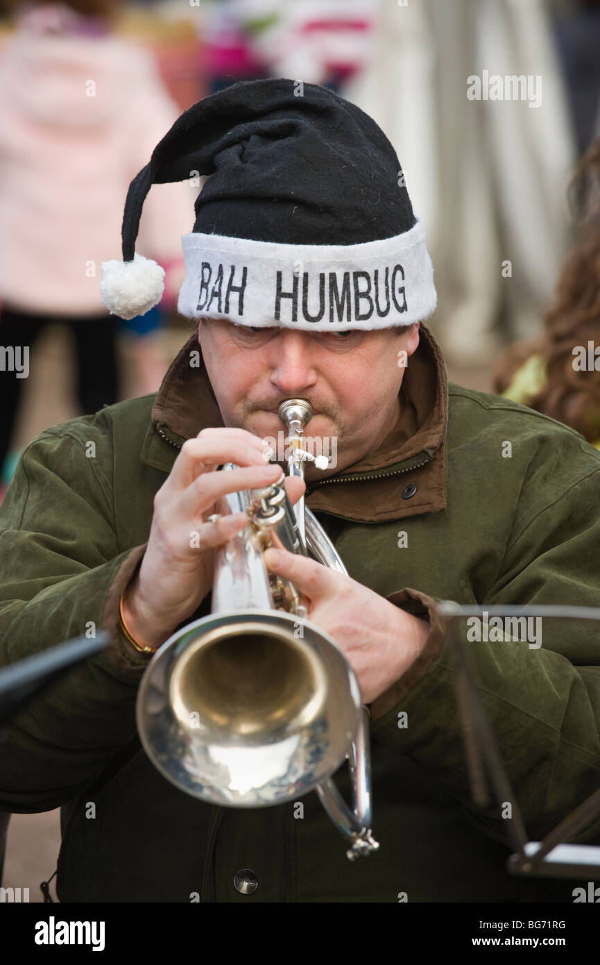 Usk Town Band playing Xmas carols duing Usk Winter Festival Usk Monmouthshire South Wales UK  trumpet player hat BAH HUMBUG Stock Photo